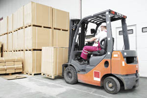 worker driver at warehouse forklift loader works